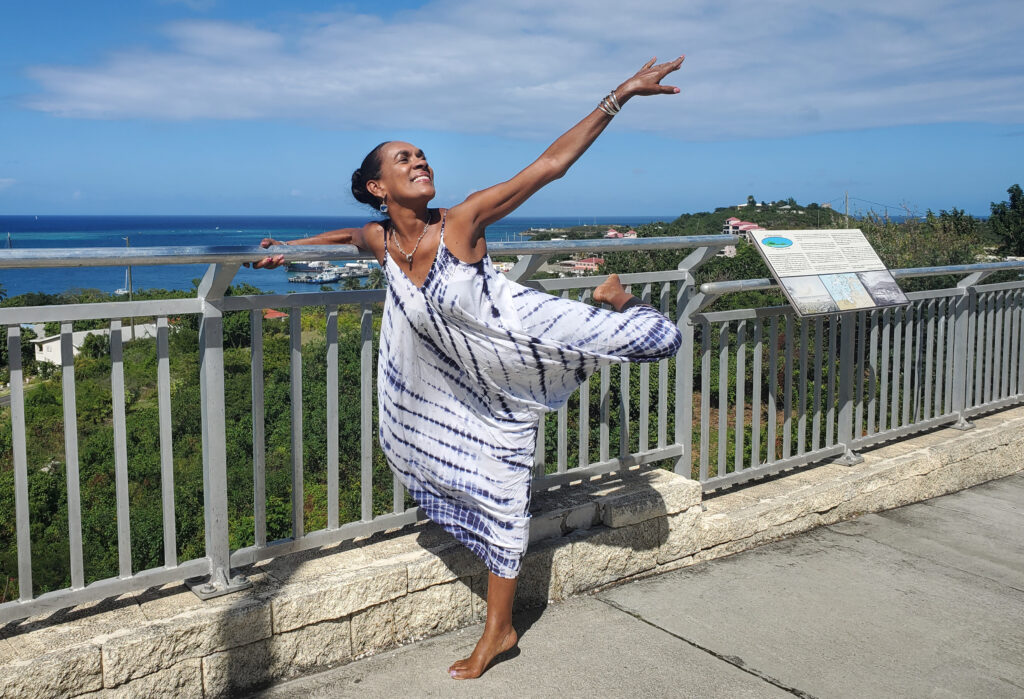 Image of Charlita Shuster in attitude derriere position, at the pier in St. Croix